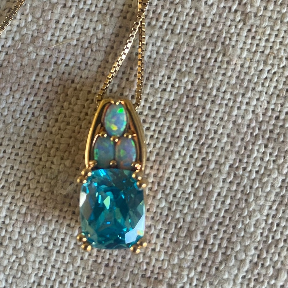 Technibond Gold over 925 Sterling
Blue cushion cut quartz with Opal accents